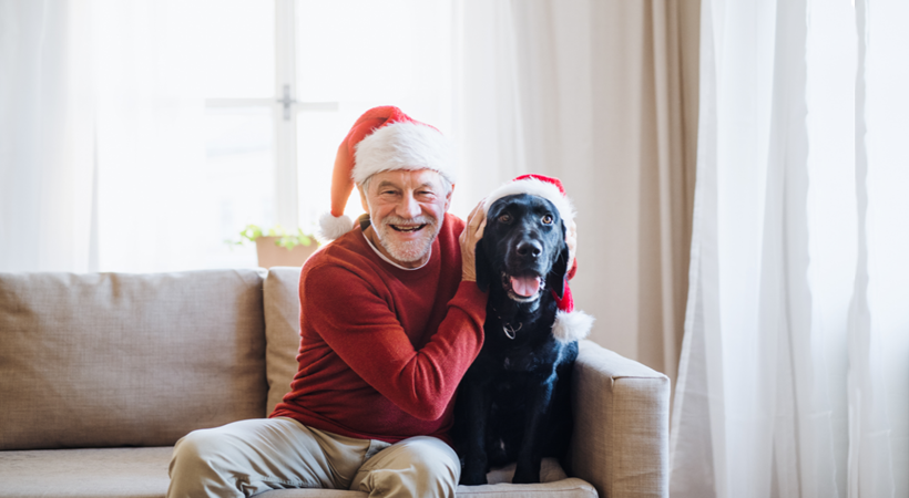 A Senior citizen sitting with his dog